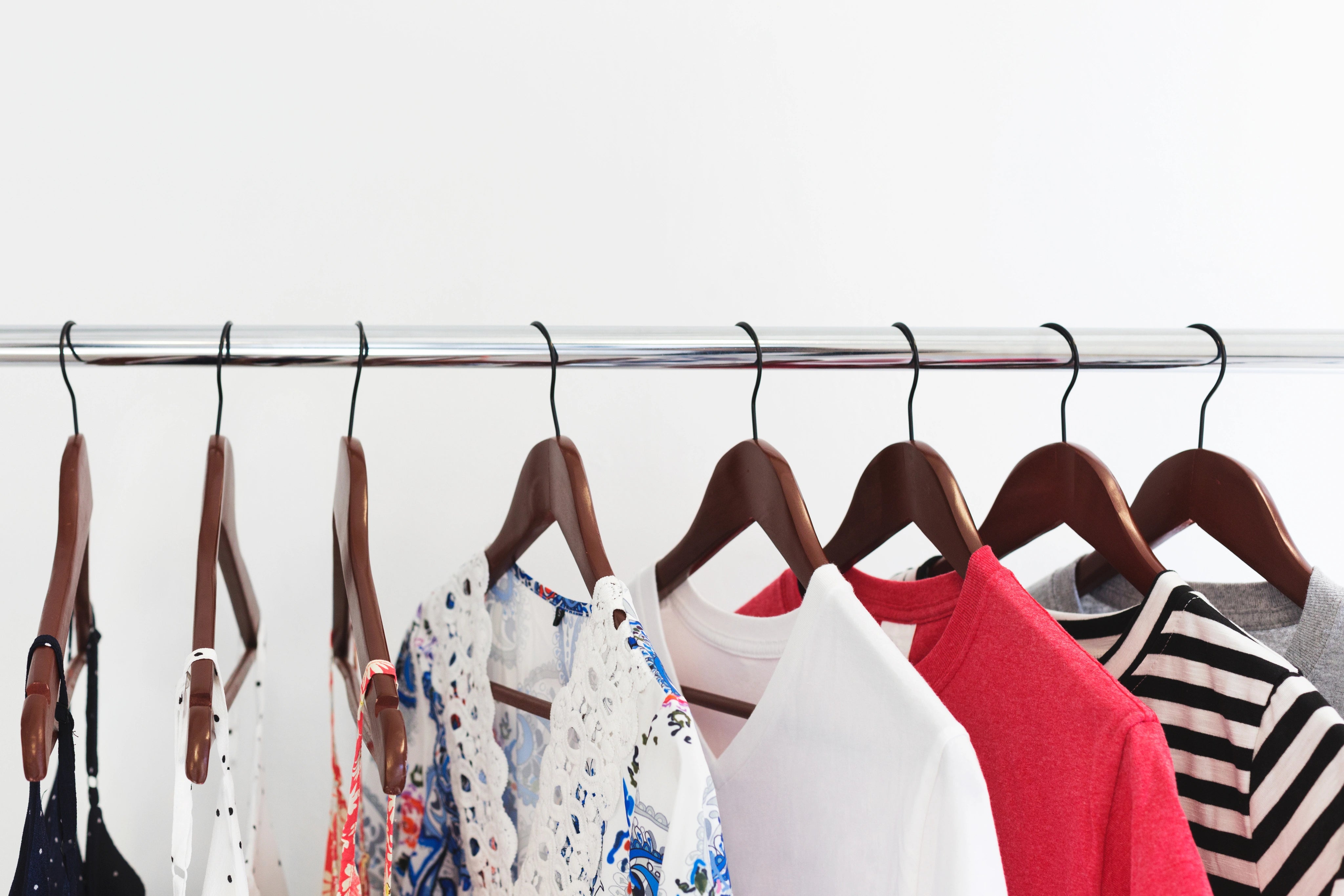 Clothing on hangers on a rack against a white background