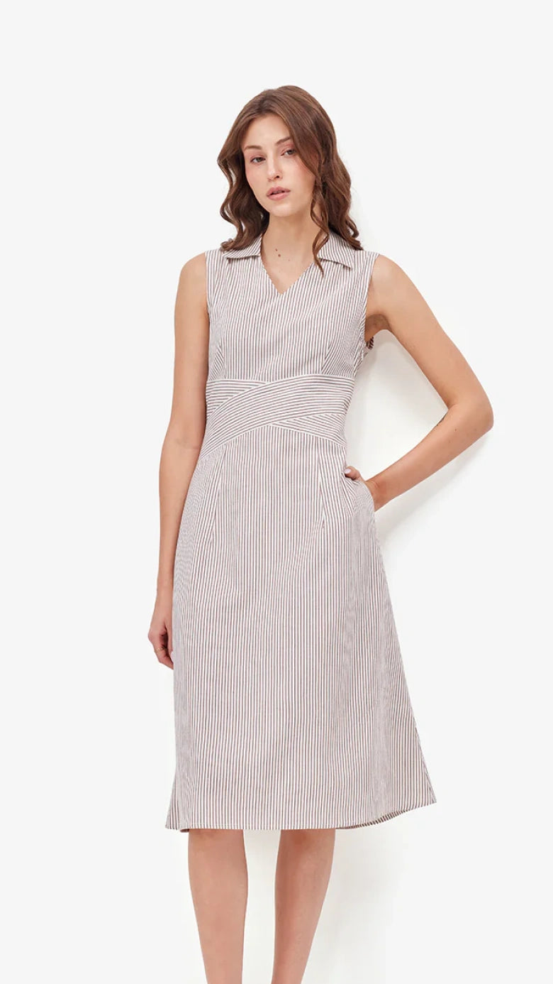 Woman wearing a sleeveless dress with a white background