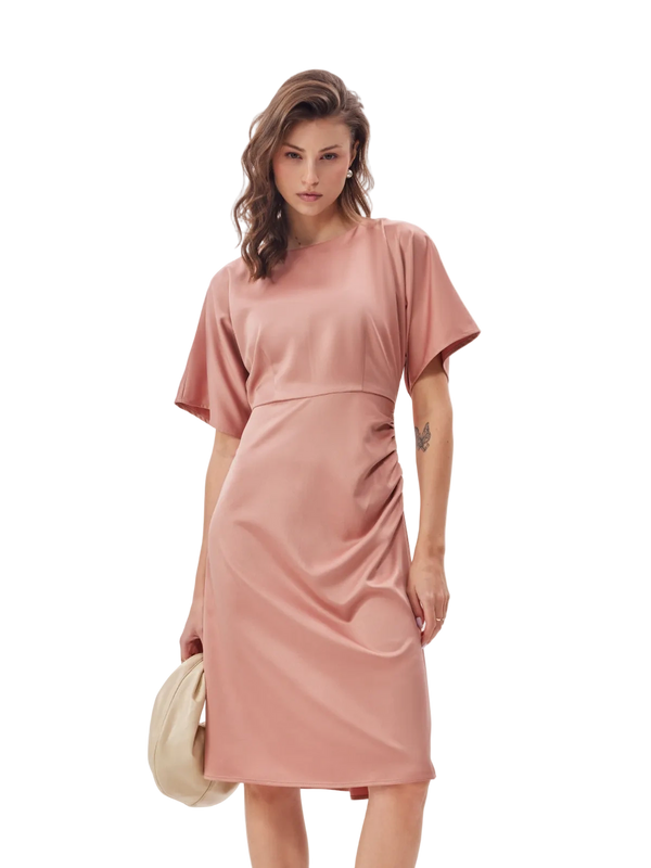Woman wearing a pink dress on a white background