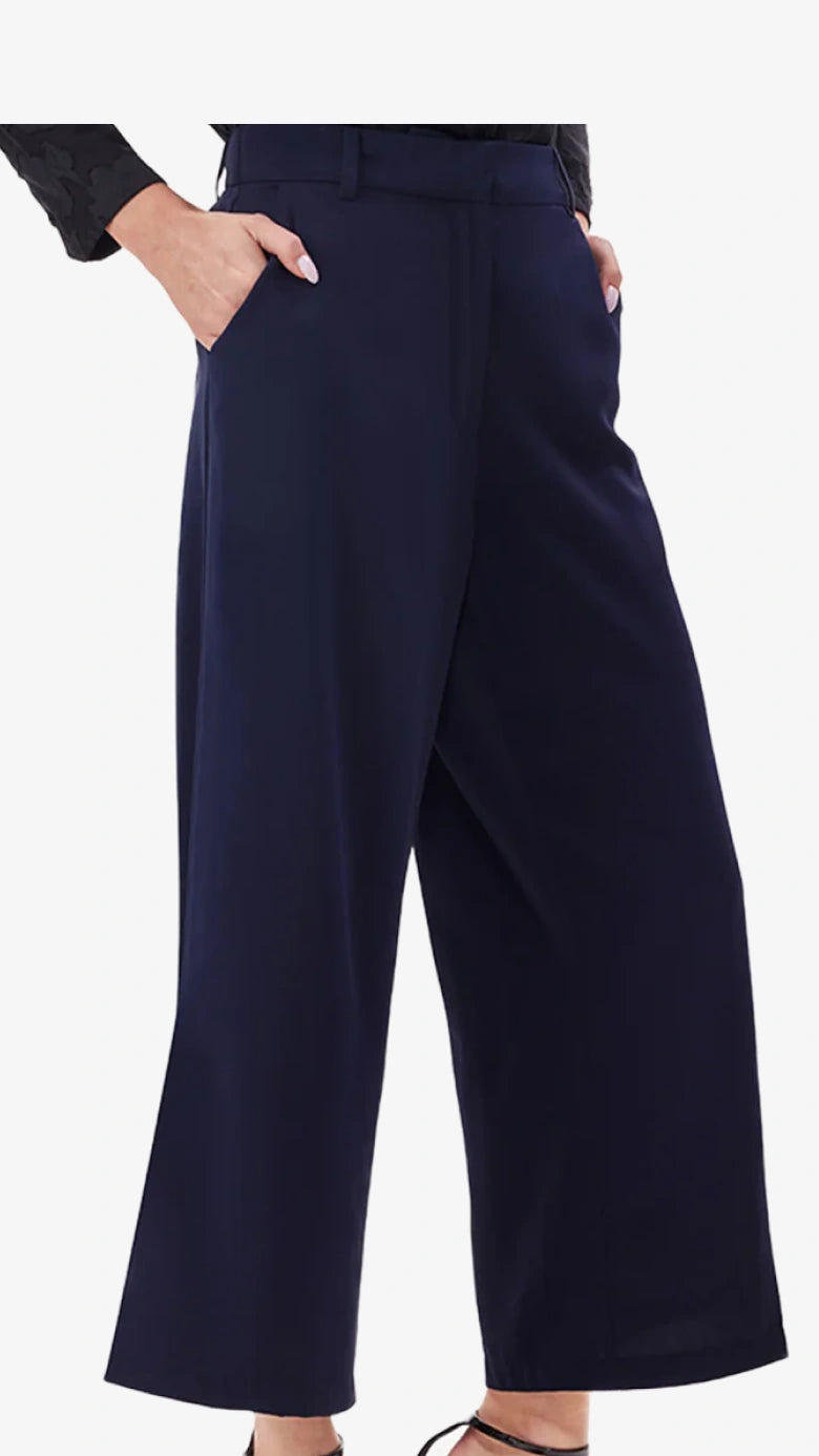 Navy blue wide-leg pants worn by a person on a white background